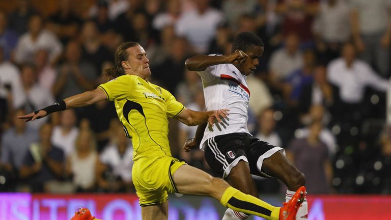 Jackson Irvine of Burton Albion tries to tackle Ryan Sessgnon of Fulham