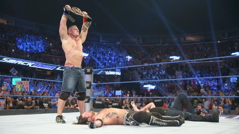 Cena holds the WWE World Title aloft