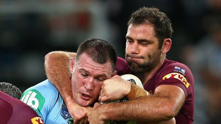 Paul Gallen of the Blues is tackled by Maroons captain Cameron Smith