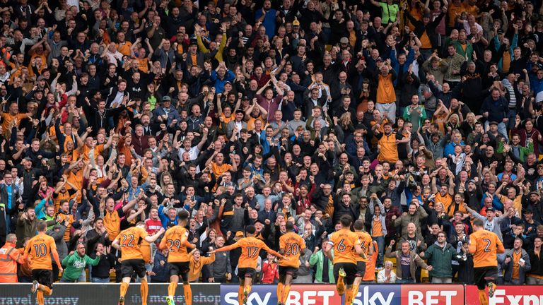 Wolves players and fans celebrate after Prince Oniangue (20) scored the opening goal