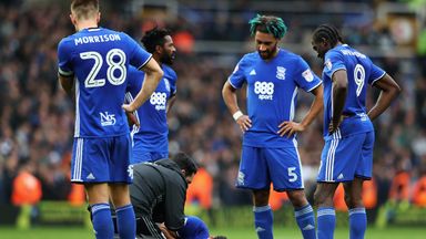 Image of Birmingham City players look on as Rhoys Wiggins lays injured