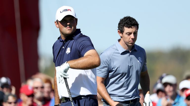 Patrick Reed of the United States and Rory McIlroy of Europe look on from the 11th tee