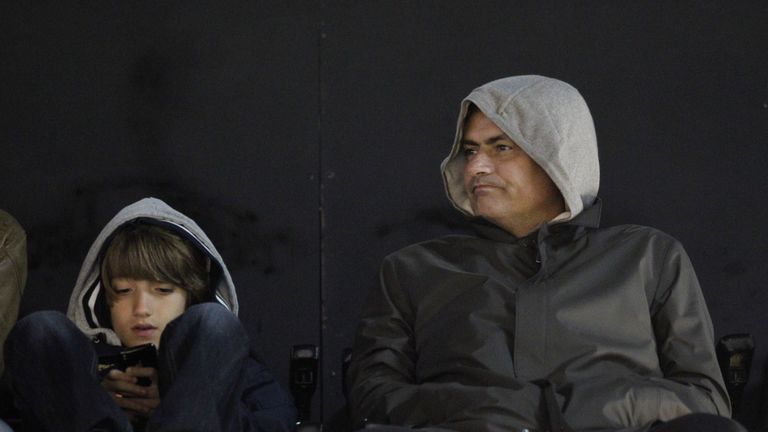 Jose Mourinho watches a game at Craven Cottage with his son