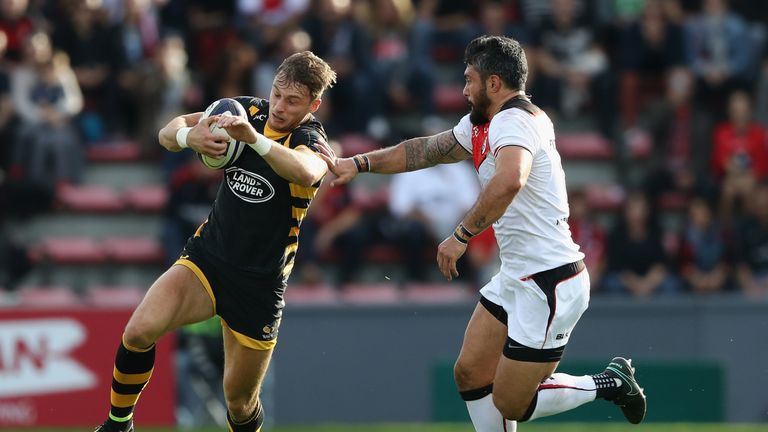 Josh Bassett (L) evades the tackle of Yann David