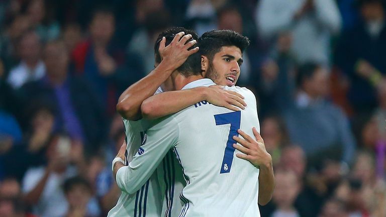 Marco Asensio celebrates scoring his team's third goal against Legia Warsaw with Cristiano Ronaldo
