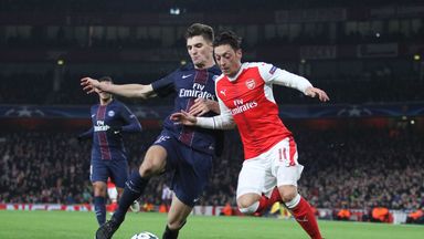 Arsenal's Mesut Ozil vies with Paris Saint-Germain's Thomas Meunier