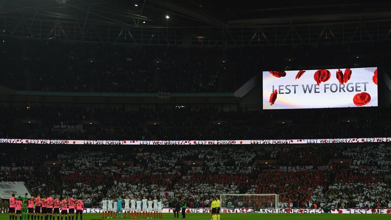 Players, officials and fans observe a silence in remembrance of Armistice Day at Wembley