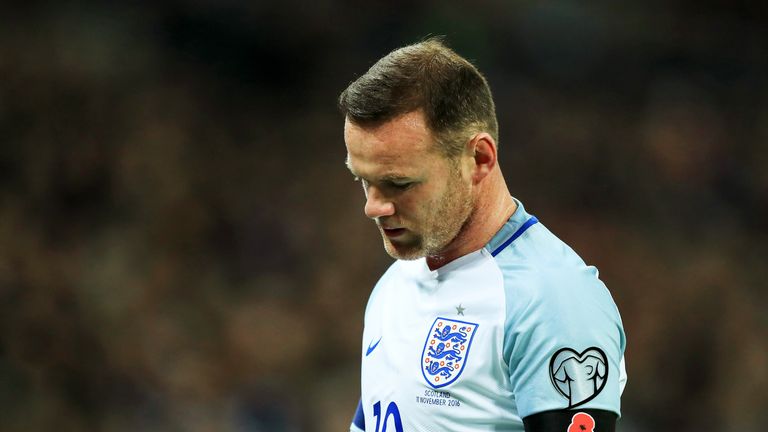 Wayne Rooney has apologised for 'inappropriate' images of him taken while on England duty