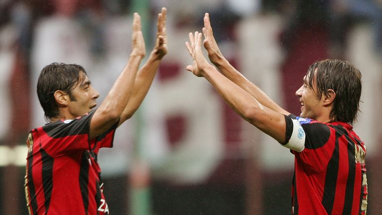Costa (L) celebrates with AC Milan captain Paolo Maldini (R)