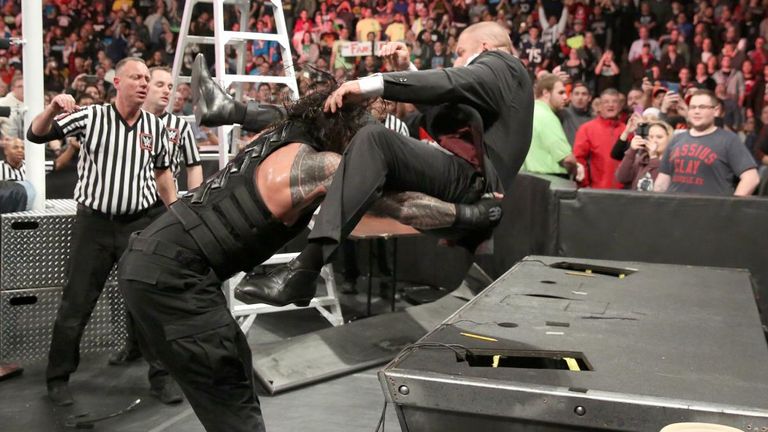 Reigns powerbombs The Game onto the announce desk