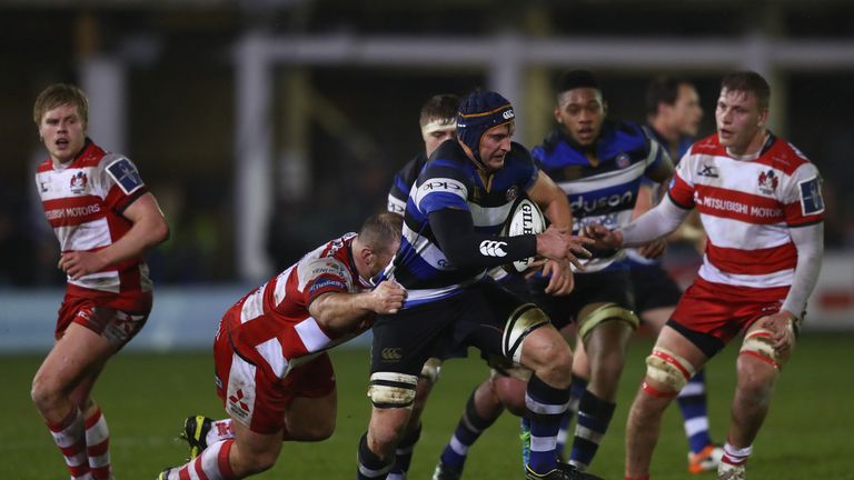 Paul Grant of Bath is tackled by Yann Thomas