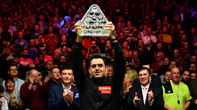 Ronnie O'Sullivan lifts the Paul Hunter Trophy following victory over Joe Perry