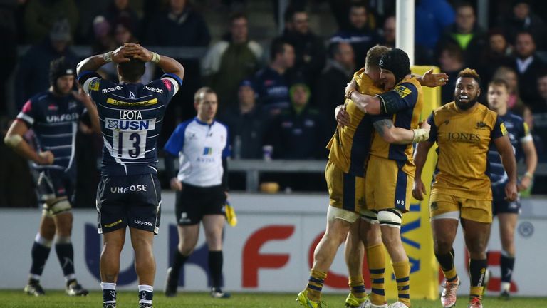Johnny Leota stands dejected as Bristol's players celebrate their win over Sale