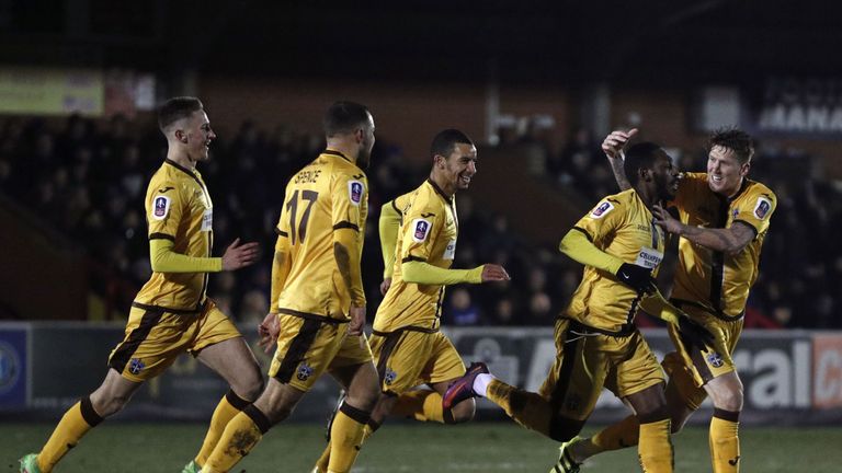 Sutton United's Roarie Deacon (2nd R) equalised for the visitors