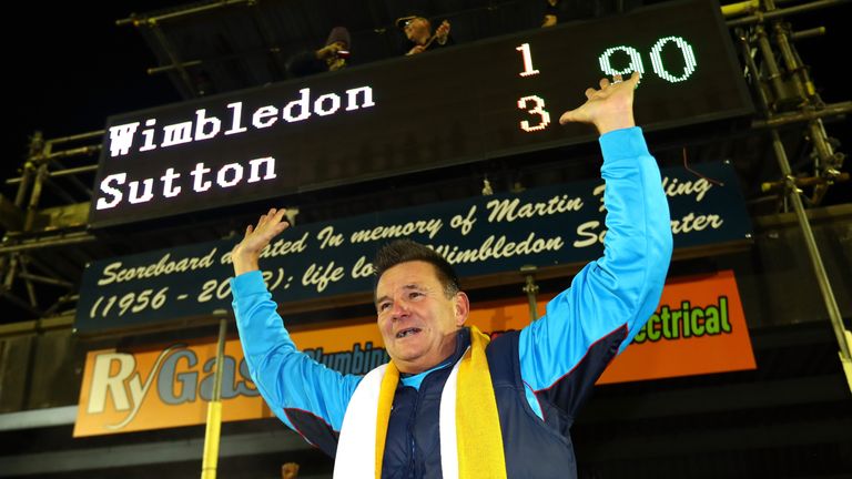 Paul Doswell, manager of Sutton, poses to photographers after the win