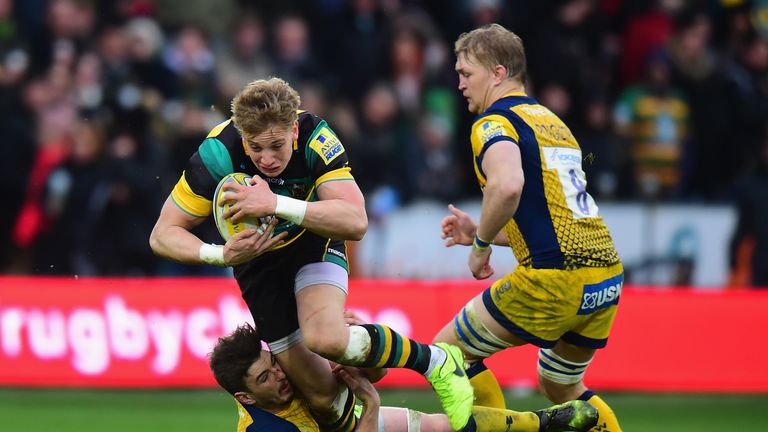 Harry Mallinder of Northampton Saints is tackled by Sam Lewis of Worcester