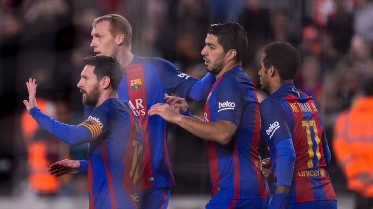 Barcelona forward Lionel Messi (L) is congratulated after scoring his side's winner against Leganes