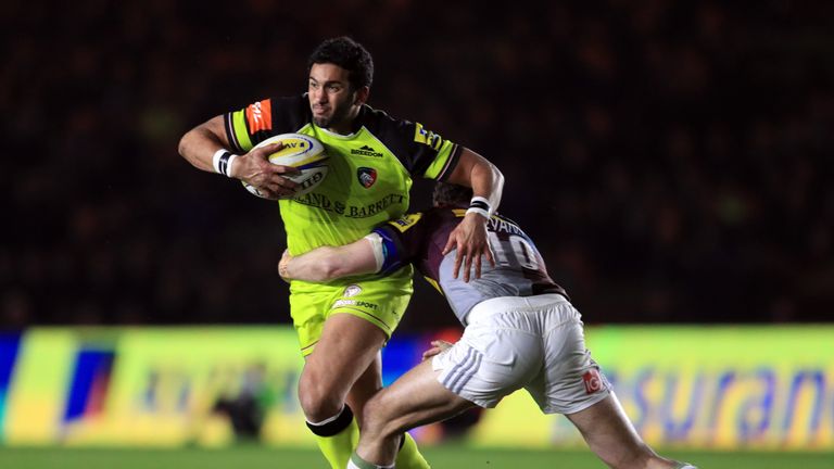 Harlequins's Nick Evans tackles Leicester's Maxime Mermoz