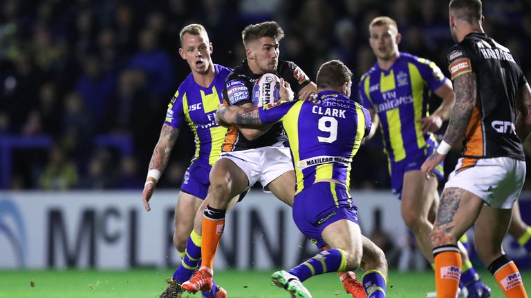 Minikin is tackled by former Tiger Daryl Clark