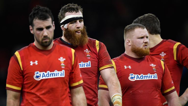 The Welsh players leave the field after their loss at the Principality Stadium