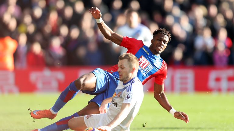 Wilfried Zaha is tackled by Sebastian Larsson