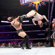 England's Jack Gallagher kicks compatriot Neville at WWE Fastlane