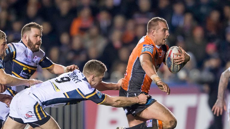 Castleford's Andy Lynch fends off tackles from Leeds's Matt Parcell