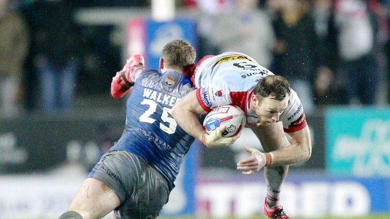 St Helens' James Roby is tackled by Wakefield's Anthony Walker