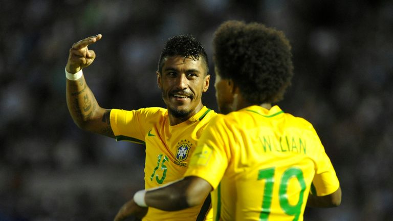Brazil midfielder Paulinho (L) celebrates with team-mate Willian after scoring his second goal against Uruguay