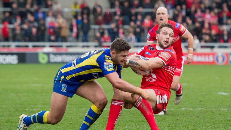 Salford's Gareth O'Brien is tackled by Warrington's Jack Johnson