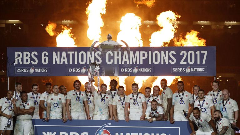 England players celebrate with the Six Nations trophy after despite the loss to Ireland