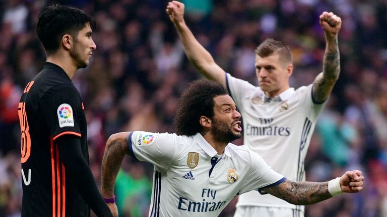 Marcelo (centre) celebrates his late strike to give Real Madrid all three points over Valencia