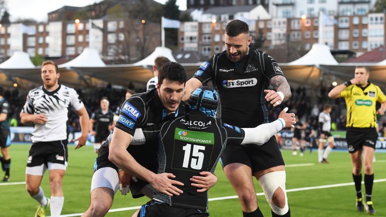 Murchie is mobbed by his team-mates after going over at the Scotstoun Stadium