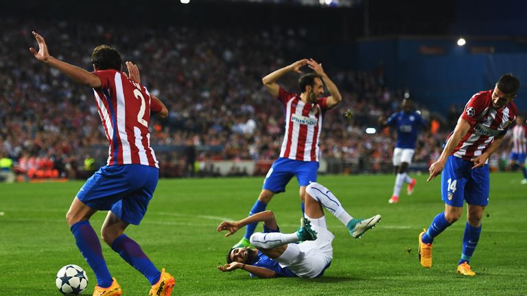 Riyad Mahrez goes to ground after a challenge by Gabi (R) of Atletico Madrid