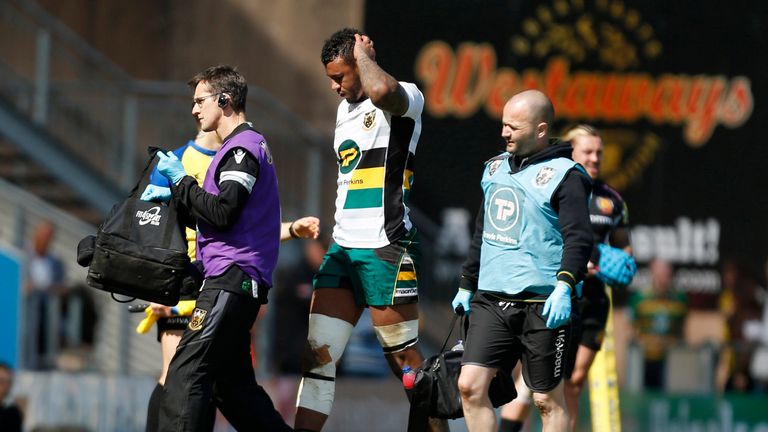 Courtney Lawes goes off injured during the first half