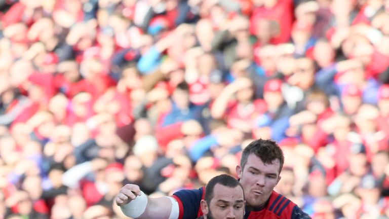 Jean-Marc Doussain (L) is tackled by Munster's Peter O'Mahony