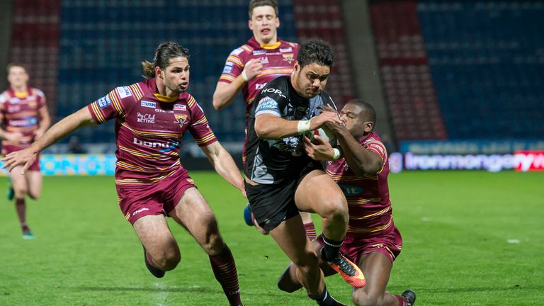 Brayden Wiliame breaks the tackles of Huddersfield's Jake Mamo (left) and Jermaine McGillvary to score a try