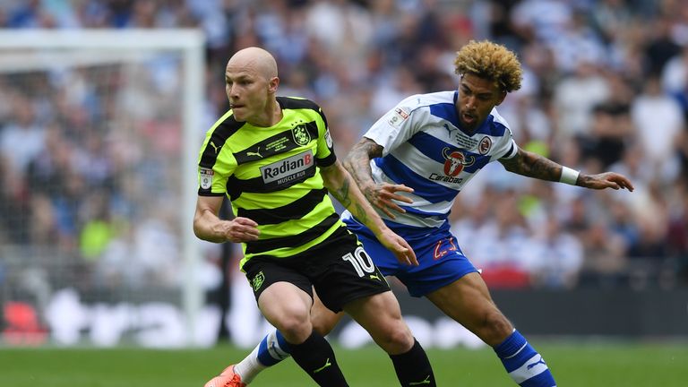 Aaron Mooy of Huddersfield Town attempts to get away from Reading's Daniel Williams