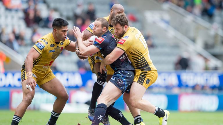 Leigh's Mitch Brown is wrapped up by Salford's defence