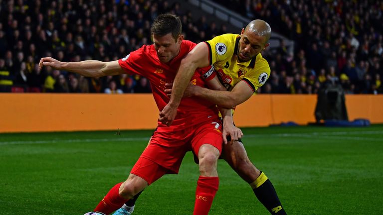 Milner of Liverpool is tackled by Nordin Amrabat of Watford