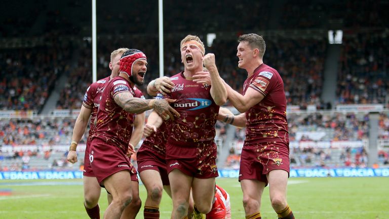 Huddersfield players celebrate with Adam O'Brien after his late try against Catalans