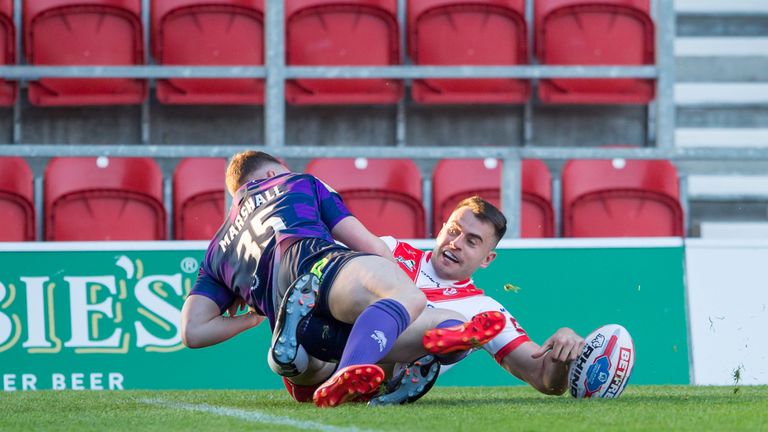 Liam Marshall cannot prevent Ryan Morgan from scoring the opening try