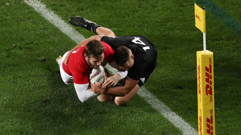 Elliot Daly of the Lions is tackled short of the tryline by Israel Dagg