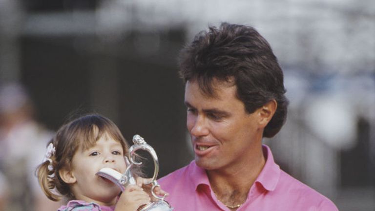 Ian Baker-Finch of Australia holds the trophy with his young daughter