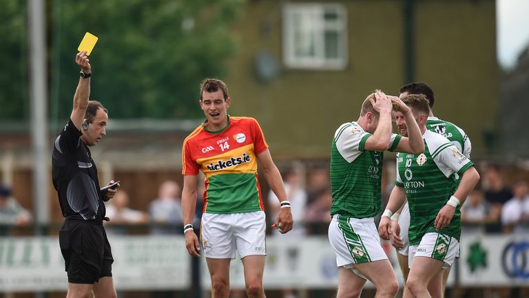 Referee Niall Cullen shows a second yellow card card to London's Jarlath Branagan (second right) 