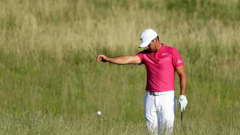 Jason Day of Australia finds his ball in the deep rough at Erin Hills