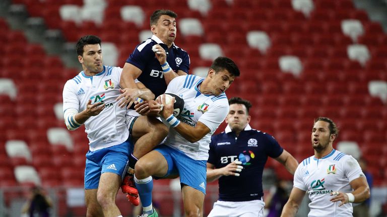 Italy's Leonardo Sarto  (L), Scotland's Damien Hoyland (C) and Tommaso Allan of Italy (R) challenge for the ball 