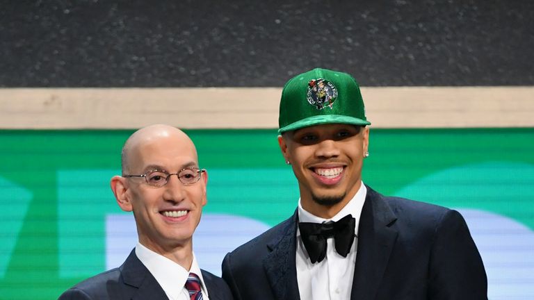 Jayson Tatum the third over all pick selected by the Boston Celtics smiles with Adam Silver 