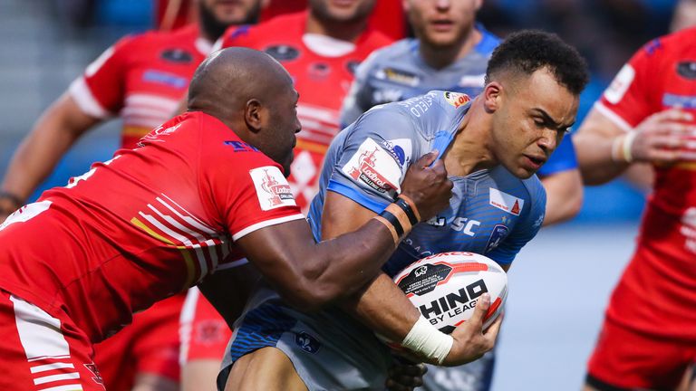 Wakefield's Mason Caton-Brown is tackled by Robert Lui