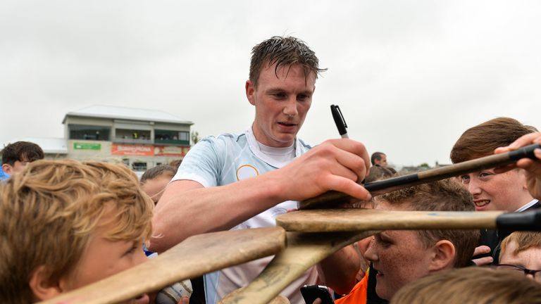 Austin Gleeson of Waterford signs hurleys for young fans following the match against Offaly 